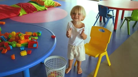 A small child plays with a construction set and claps his hands Video stock 194683170