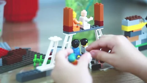A small child plays a construction set. Construction of cubes. Stock Footage 207833742