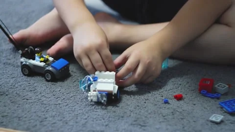 A small child plays a construction set. Construction of cubes. Stock Footage 218007331