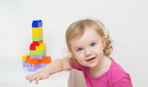 A small child plays with a constructor. cute girl and toys Stock Photos