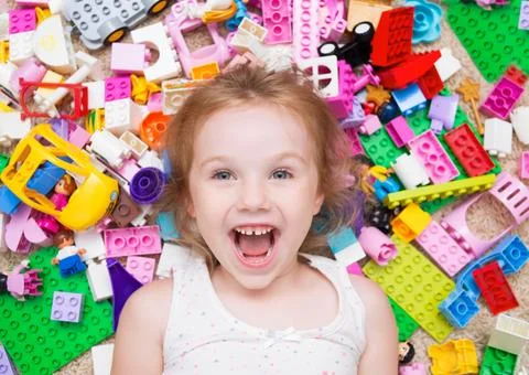 A small child plays with a constructor. cute girl and toys Stock Photos