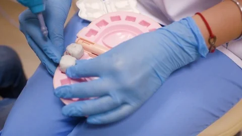 A small child plays with a dentist in a dentist's toy tools. Stock Footage 84785559