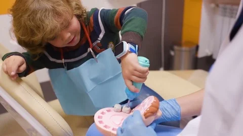 A small child plays with a dentist in a dentist's toy tools. Stock Footage 84785699