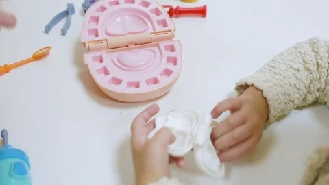 A small child plays with a dentist in a dentist's toy tools. Stock Footage 84787846