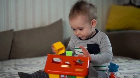 The Small Child Plays With Figures. Logical Toy Stock Footage 76132154