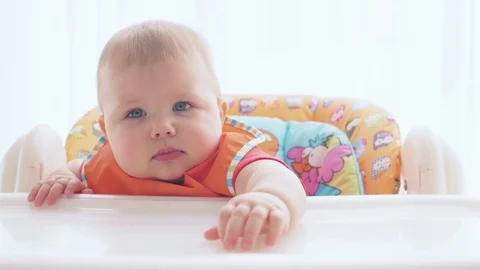 Small child with pleasure eats food with a spoon Video stock 72665184
