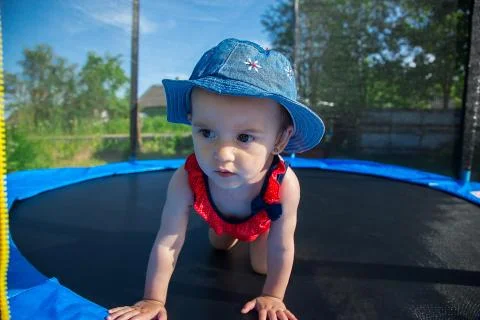 A small child posing on a trampoline Stock Photos
