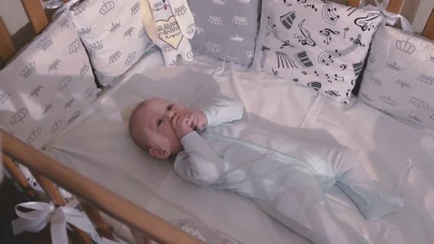 Small child puts his hand in himself mouth Stock Footage 80537060