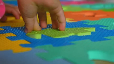 Small child putting puzzle piece into puzzle Stock Footage 40951732
