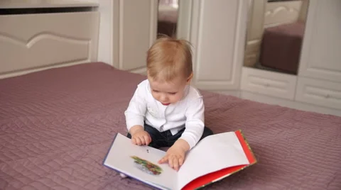 The small child reads the book 스톡 동영상 62651640
