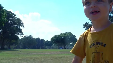 Small child running all around in a park . 4k 2017 스톡 동영상 82069635