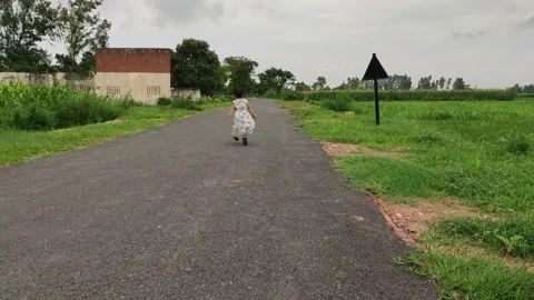 Small child running alone on road Stock Footage 141480743