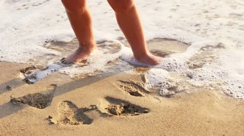 Small child running along the beach at sunset Stock Footage 55573348