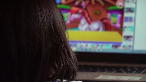 Small child seen from behind watching a laptop screen. Concept of e-learning, Stock Footage 325494446