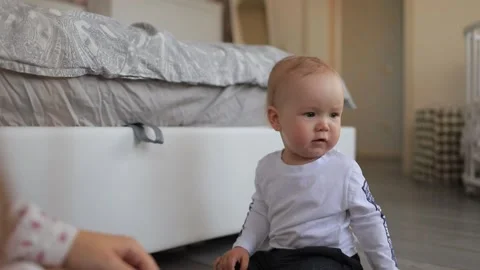 A small child sits on the floor Stock Footage 131631189