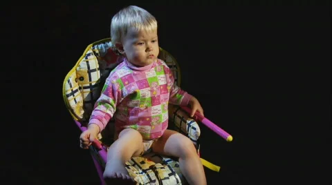 Small child sits on a stool Stock Footage 533554