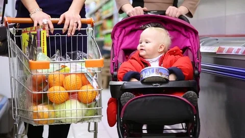 Small child in stroller in supermarket Stock Footage 72399684