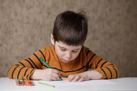 A small child is studying at the computer. Distance learning at home quarantine Stock Photos