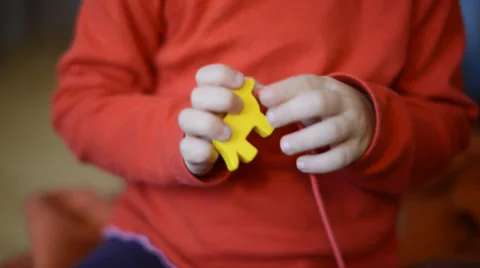 Small child threading a chain Stock Footage 30594680