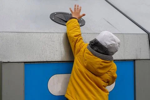 A small child throws garbage into a huge trash can. Caring for nature and eco Stock Photos