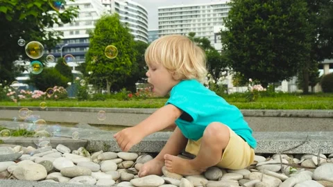 A small child tries to catch soap bubbles with his mouth Stock Footage 200807292