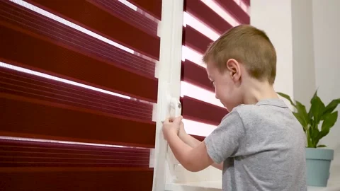 A small child tries to open a balcony door closed to a key. Children window Vidéo 150965358