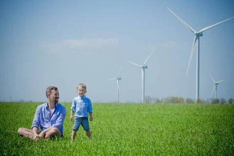 A small child under the influence of wind generators Stock Photos