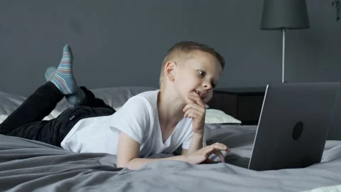 A Small Child Uses A Computer, Looks at The Laptop Screen, Watches Videos 스톡 동영상 157815599