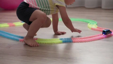 Small children are playing with constructor of race track Video stock 137827105