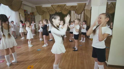 Small children group learns active joyful dance in class Stock Footage 98287865