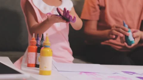Small children hands hold wax crayons to draw rainbow on paper sheet. Diver.. Stock Footage 339643002