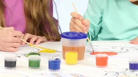 Small children with the help of brushes and paints decorate drawings, they like Vidéo 76120551