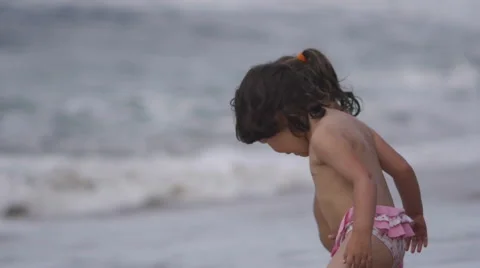 Small children looking at the waves Stock Footage 64212001