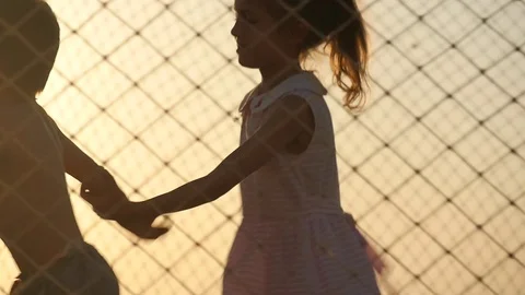 Small children playing on the trampoline on a background of sea sunset Stock Footage 73082628
