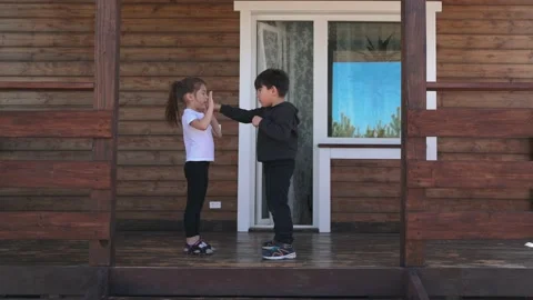 Small children practice boxing punches while practicing on a beautiful veranda A Stock Footage 153910679