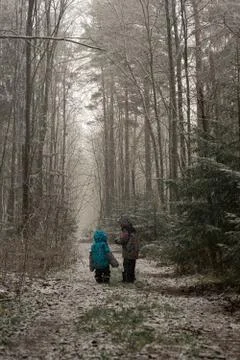 Small children walking under first snow 스톡 사진