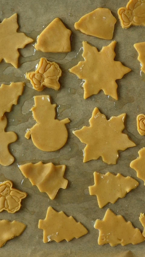 Small children's hands placing gingerbread tree on parchment paper Stock Footage 294437077