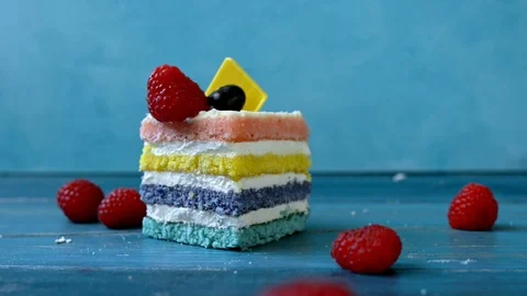 Small children's hands take rainbow cake with raspberries and blueberrie Stock Footage 123611744