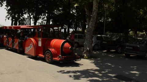A small children’s train passing by near a city beach in Split Stock Footage 49765698