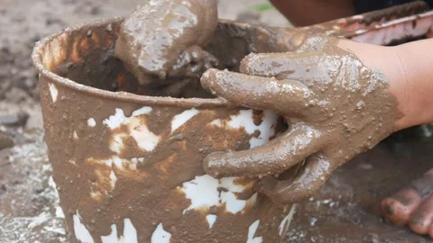 Small Childs hands playing with sand and mud. child playing outdoors with mud Stock Footage 312097550