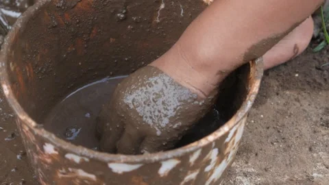 Small Childs hands playing with sand and mud. child playing outdoors with mud Stock Footage 312097585