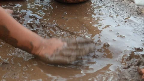 Small Childs hands playing with sand and mud. child playing outdoors with mud Stock Footage 312097605
