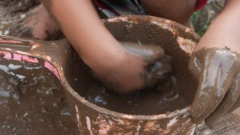 Small Childs hands playing with sand and mud. child playing outdoors with mud Stock Footage 312097616