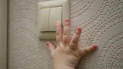 A small child's pen reaches for the switch. HD, 1920x1080, slow motion. Stock Footage 147139352