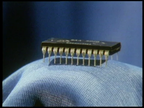 Small chip component from machine on blue background and launch of rocket, 1985 Video stock 136673872