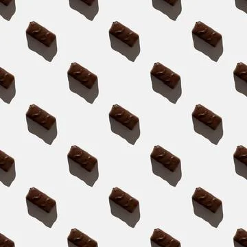 Small chocolate bar on a light background. seamless pattern. Background image Stock Photos