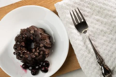 Small Chocolate Bunt cake with a fork. Stock Photos