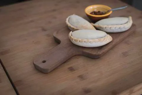 Small chopping board displaying typical food from Portugal and South America, Stock Photos