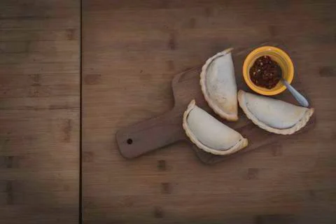 Small chopping board displaying typical food from Portugal and South America, Stock Photos
