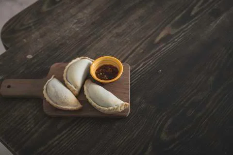 Small chopping board displaying typical food from Portugal and South America, Stock Photos